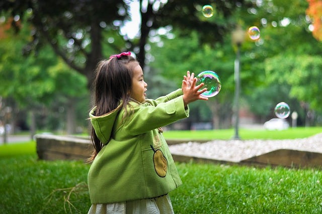 child touching bubble