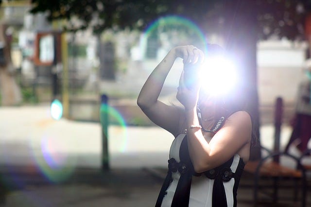 Woman using camera flash