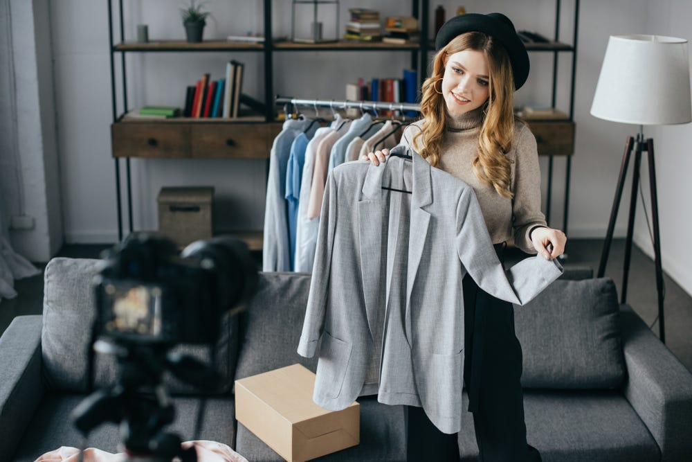 fashion-vlogger-holds-up-garment-to-video-camera