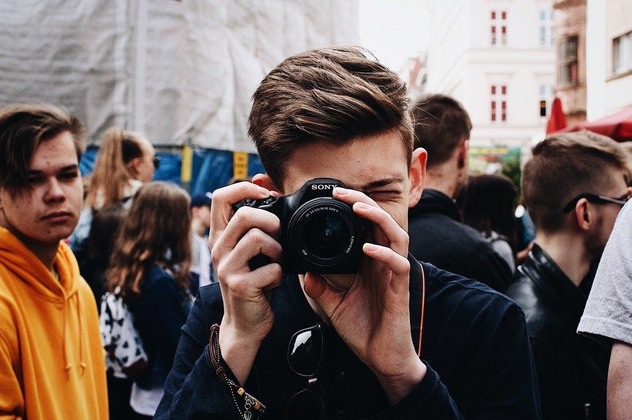 a man holding a sony full frame camera
