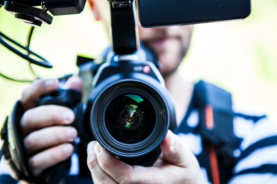 man holding video camera setup