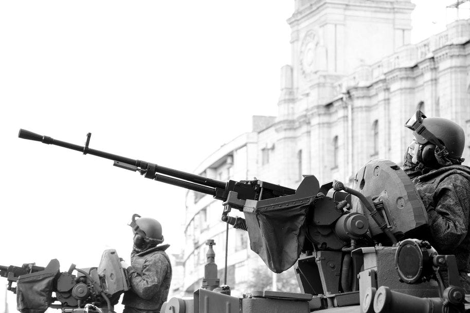 men in tanks protecting building