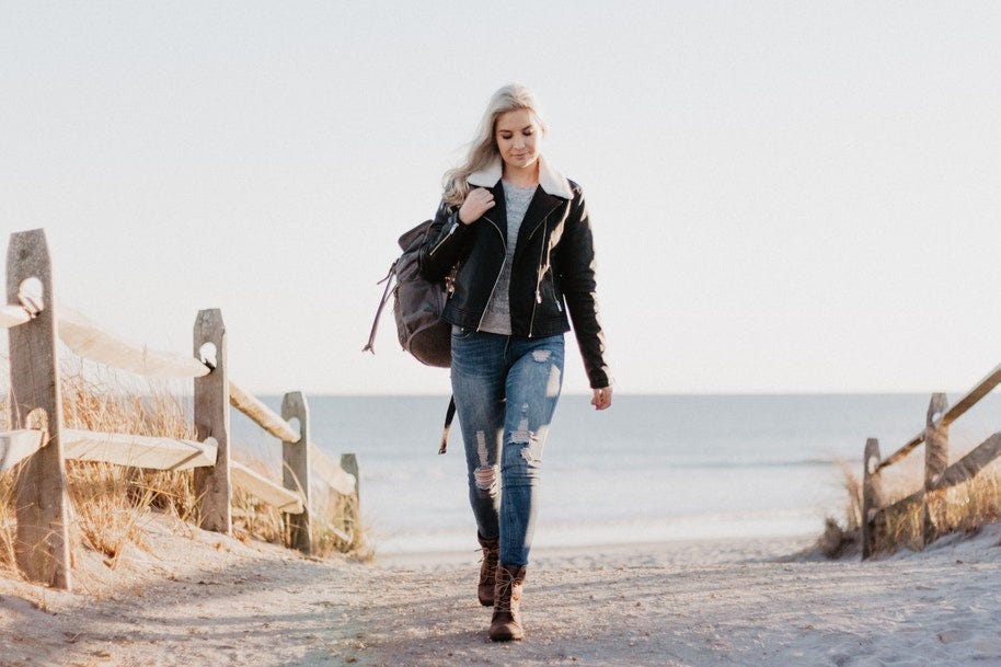 woman walking up from beach