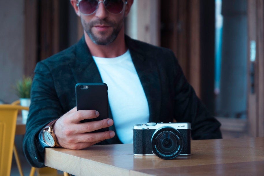 man holding smart phone with camera