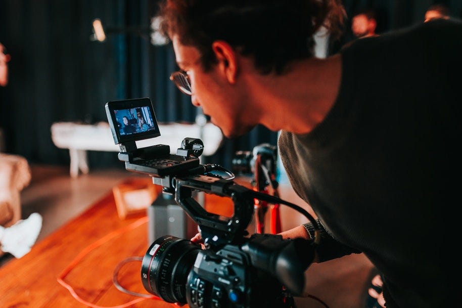 A filmmaker holding a professional camera