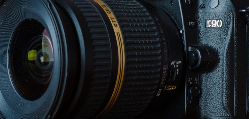 A Tamron lens up close on a D90 Nikon camera. 